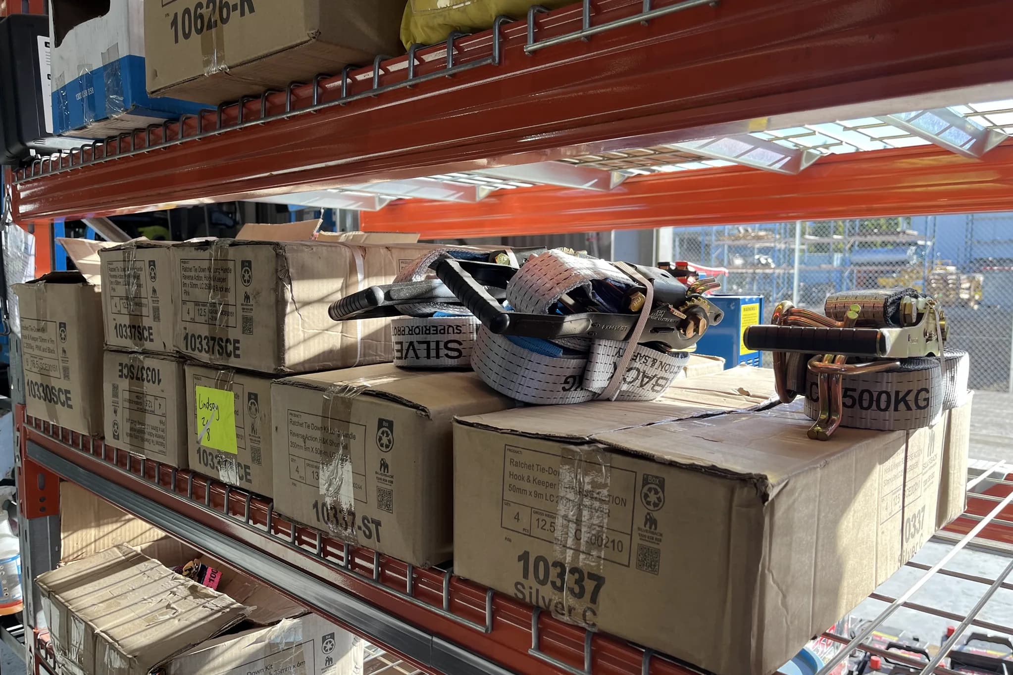 Silverback ratchet tie-down boxes on pallet racking at the Townlec workshop in Townsville, with strap kits opened on top of them