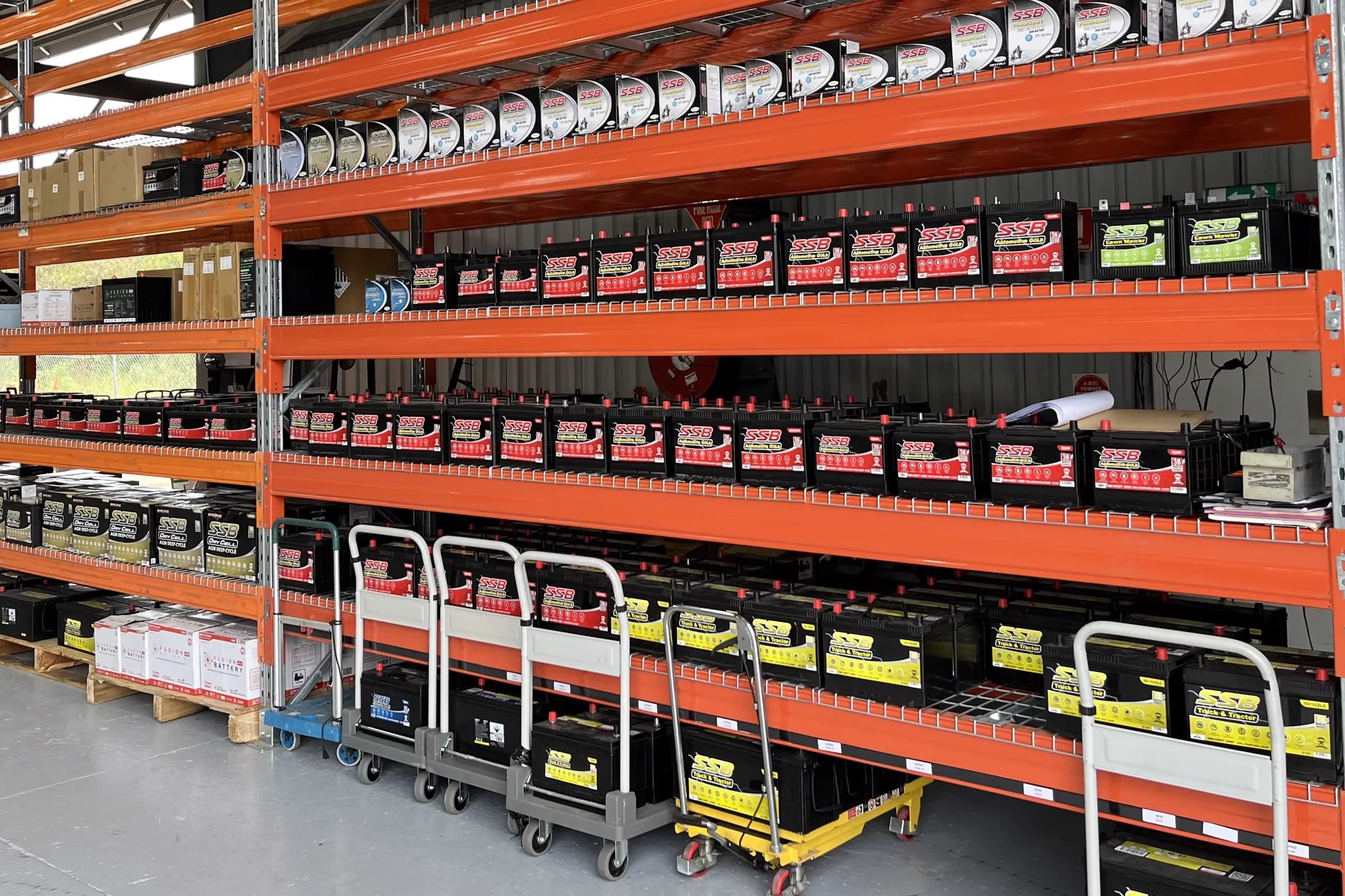 SSB Automotive Gold, Truck & Tractor and other batteries on orange pallet racking at the Townlec workshop in Townsville